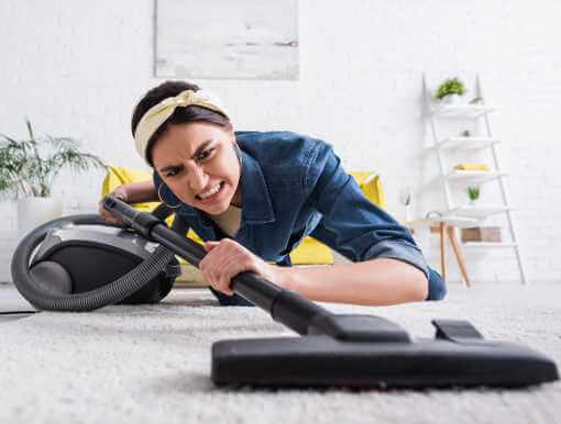 Frustrated Woman Vacuuming