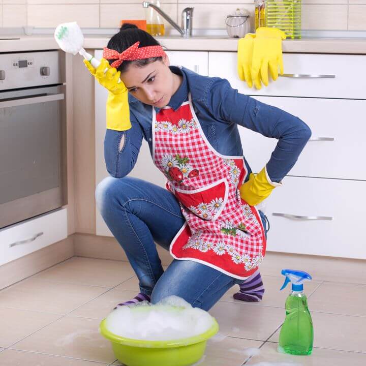 Woman Scrubbing Tile Floor